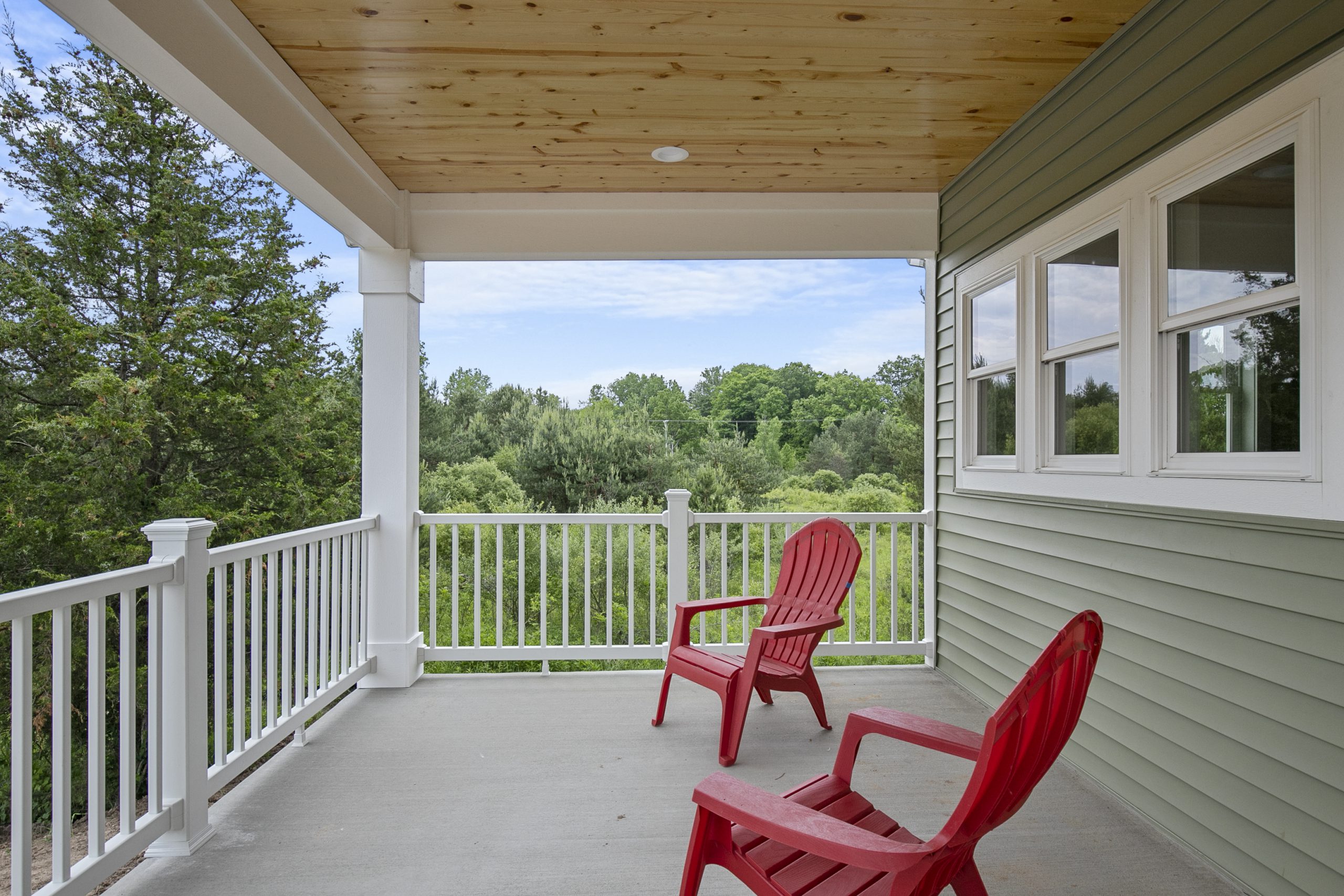 a deck with chairs and a porch